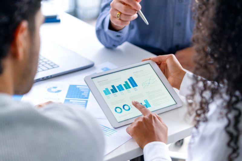 Business professionals collaborating with tablet analytics