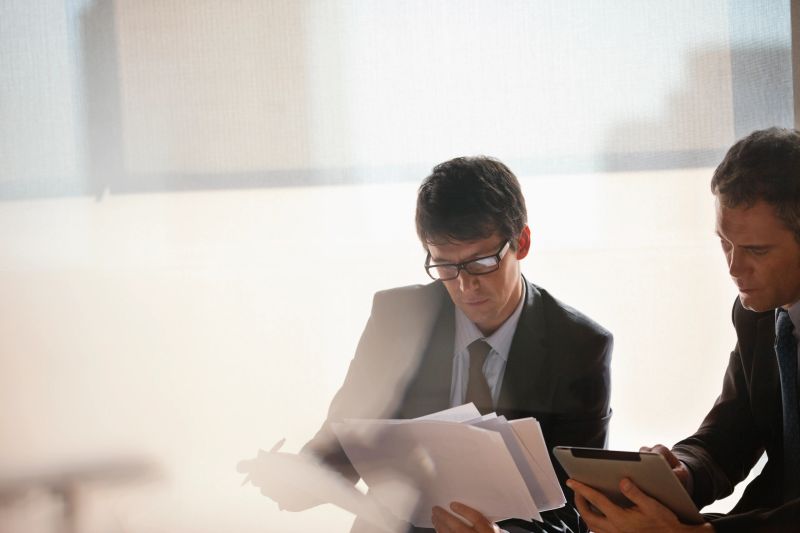 Business professionals reviewing documents in a modern office
